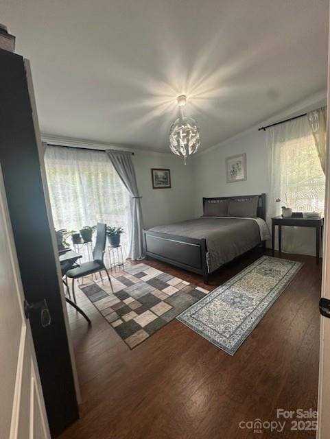 3211 Winding Trl, Matthews, NC 28105 - bedroom featuring multiple windows, wood finished floors, and a chandelier