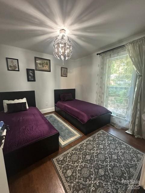 3211 Winding Trl, Matthews, NC 28105 - bedroom with wood finished floors, crown molding, and a chandelier