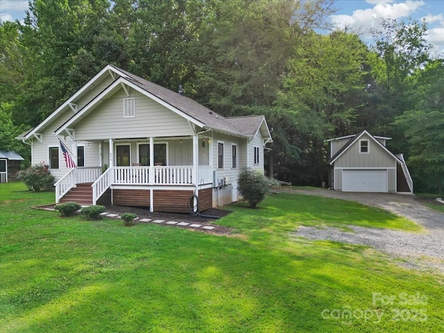 275 Haynes Dr, Salisbury, NC 28146 - view of front facade with an outdoor structure, covered porch, a garage, and a front lawn