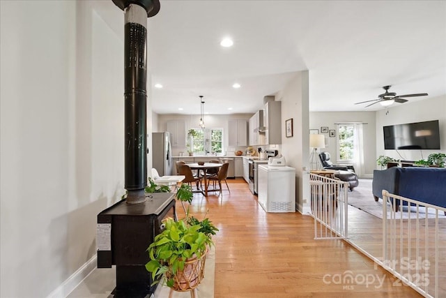 275 Haynes Dr, Salisbury, NC 28146 - living area with healthy amount of natural light, a wood stove, light wood finished floors, a ceiling fan, and recessed lighting