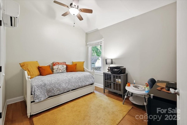 275 Haynes Dr, Salisbury, NC 28146 - bedroom featuring a wall unit AC, wood finished floors, a ceiling fan, and an office area