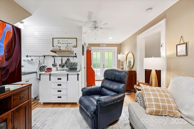 275 Haynes Dr, Salisbury, NC 28146 - living area with ceiling fan, light wood-type flooring, french doors, and wood walls
