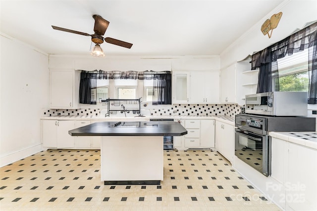 135 Corban Ave SE, Concord, NC 28025 - kitchen featuring ornamental molding, white cabinets, and backsplash
