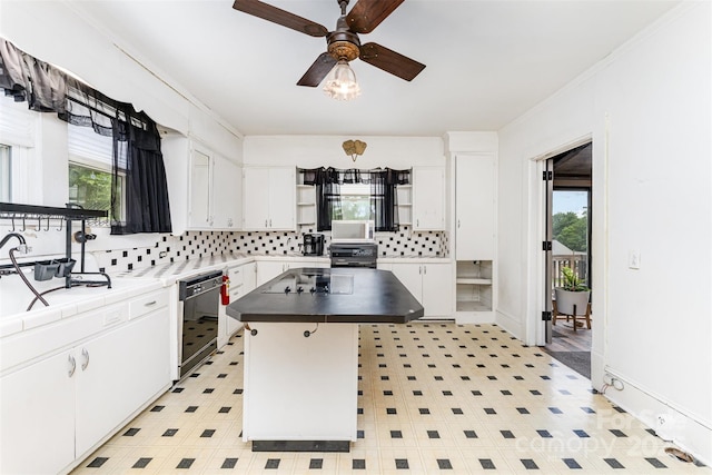 135 Corban Ave SE, Concord, NC 28025 - kitchen with open shelves, black appliances, plenty of natural light, and decorative backsplash