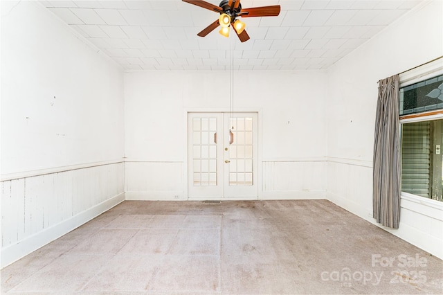 135 Corban Ave SE, Concord, NC 28025 - empty room with ceiling fan, carpet, wainscoting, and french doors