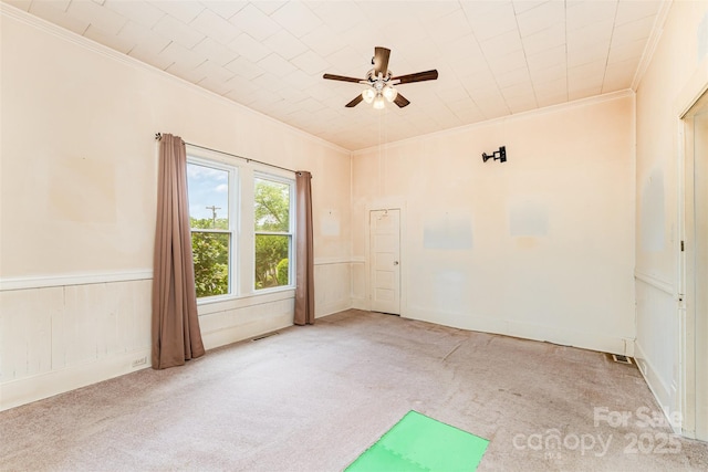 135 Corban Ave SE, Concord, NC 28025 - empty room with ornamental molding, carpet, ceiling fan, and wainscoting