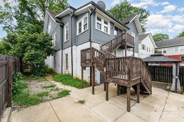 135 Corban Ave SE, Concord, NC 28025 - rear view of property with a patio, a gazebo, stairway, a fenced backyard, and brick siding