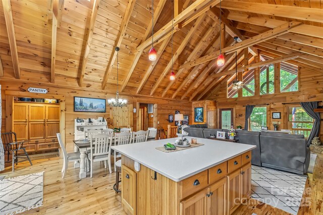 279 Outback Trl, Nebo, NC 28761 - kitchen featuring wooden walls, a chandelier, a center island, open floor plan, and light countertops