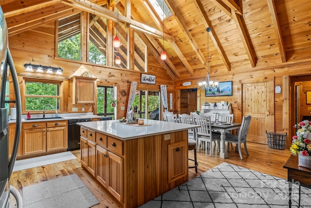 279 Outback Trl, Nebo, NC 28761 - kitchen featuring dishwasher, light wood-style flooring, wood walls, light countertops, and a chandelier