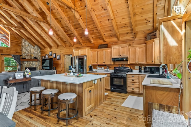 279 Outback Trl, Nebo, NC 28761 - kitchen featuring black appliances, under cabinet range hood, light wood-style floors, a wooden ceiling with exposed beams, and light countertops