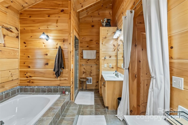 279 Outback Trl, Nebo, NC 28761 - bathroom featuring vanity, a relaxing tiled tub, wood walls, and tile patterned flooring