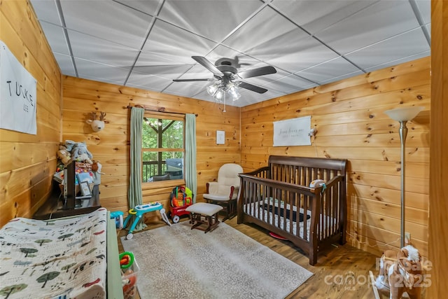 279 Outback Trl, Nebo, NC 28761 - bedroom featuring wood finished floors, wooden walls, and ceiling fan