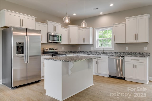 521 Tram Rd, Lancaster, SC 29720 - kitchen with appliances with stainless steel finishes, light wood-style floors, white cabinets, and recessed lighting