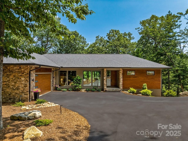 23 Haverhill Ct, Flat Rock, NC 28731 - view of front of property with driveway, an attached garage, and roof with shingles
