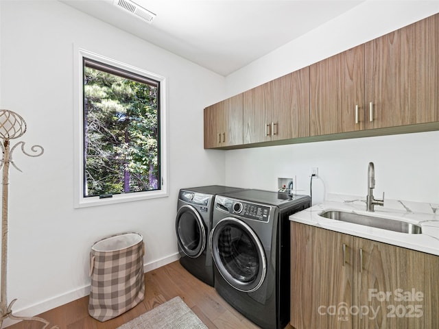 23 Haverhill Ct, Flat Rock, NC 28731 - laundry area with cabinet space, washing machine and dryer, and light wood finished floors