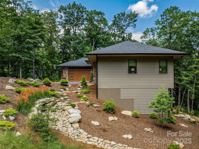 23 Haverhill Ct, Flat Rock, NC 28731 - view of side of home featuring a garage and a shingled roof