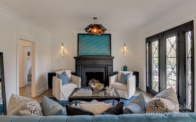 3306 Gaston Rd, Greensboro, NC 27407 - living area featuring a fireplace, light wood-type flooring, and ornamental molding