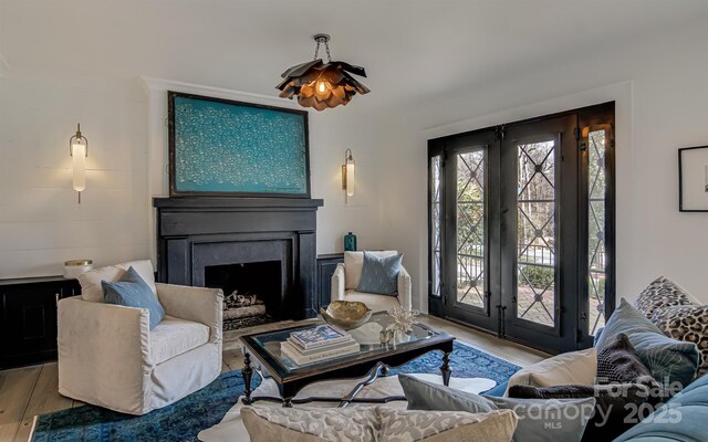 3306 Gaston Rd, Greensboro, NC 27407 - living room featuring wood finished floors, a fireplace, and french doors