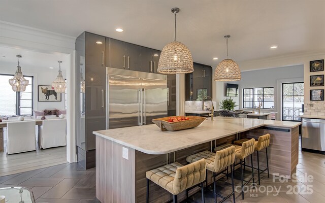 3306 Gaston Rd, Greensboro, NC 27407 - kitchen with stainless steel appliances, a kitchen bar, a large island, decorative backsplash, and recessed lighting