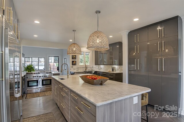 3306 Gaston Rd, Greensboro, NC 27407 - kitchen with high end appliances, tasteful backsplash, a large island, a breakfast bar, and glass insert cabinets