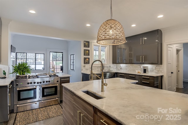 3306 Gaston Rd, Greensboro, NC 27407 - kitchen with range with two ovens, decorative backsplash, recessed lighting, glass insert cabinets, and hanging light fixtures