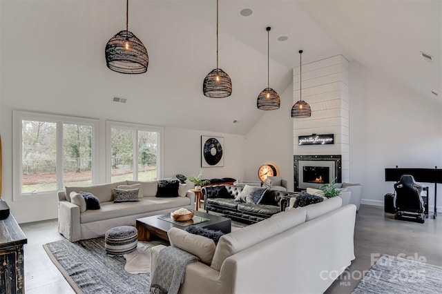 3306 Gaston Rd, Greensboro, NC 27407 - living area featuring high vaulted ceiling, healthy amount of natural light, and a fireplace