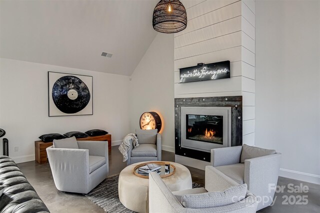 3306 Gaston Rd, Greensboro, NC 27407 - living room featuring a large fireplace, finished concrete floors, and vaulted ceiling