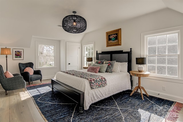 3306 Gaston Rd, Greensboro, NC 27407 - bedroom featuring lofted ceiling, multiple windows, and hardwood / wood-style floors
