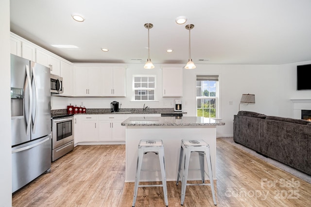 1026 Baileys Chapel Rd, Advance, NC 27006 - kitchen with appliances with stainless steel finishes, open floor plan, white cabinetry, and recessed lighting