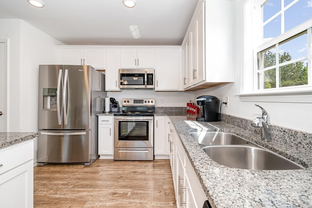 1026 Baileys Chapel Rd, Advance, NC 27006 - kitchen with stainless steel appliances, white cabinetry, recessed lighting, light wood-style flooring, and light stone countertops