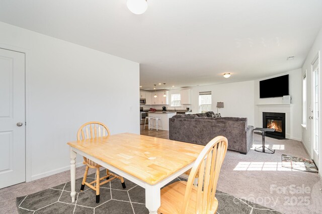 1026 Baileys Chapel Rd, Advance, NC 27006 - dining area featuring light colored carpet and a glass covered fireplace