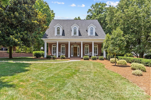 6716 Southby Ct, Charlotte, NC 28270 - cape cod house featuring brick siding, a front yard, covered porch, and roof with shingles