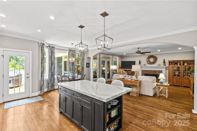 6716 Southby Ct, Charlotte, NC 28270 - kitchen featuring arched walkways, dark cabinets, a ceiling fan, recessed lighting, and light wood-style floors