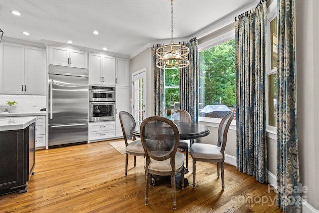 6716 Southby Ct, Charlotte, NC 28270 - dining room with a chandelier, light wood finished floors, crown molding, and recessed lighting