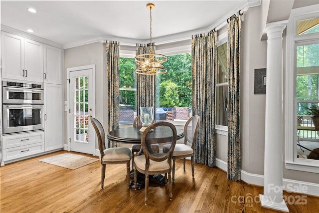 6716 Southby Ct, Charlotte, NC 28270 - dining space with a chandelier, light wood-style flooring, recessed lighting, ornamental molding, and ornate columns
