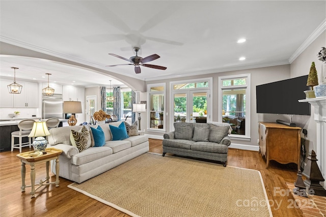 6716 Southby Ct, Charlotte, NC 28270 - living area featuring crown molding, light wood finished floors, recessed lighting, ceiling fan, and arched walkways