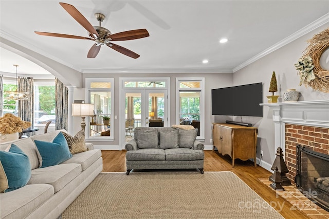 6716 Southby Ct, Charlotte, NC 28270 - living area featuring a brick fireplace, crown molding, a chandelier, french doors, and a ceiling fan