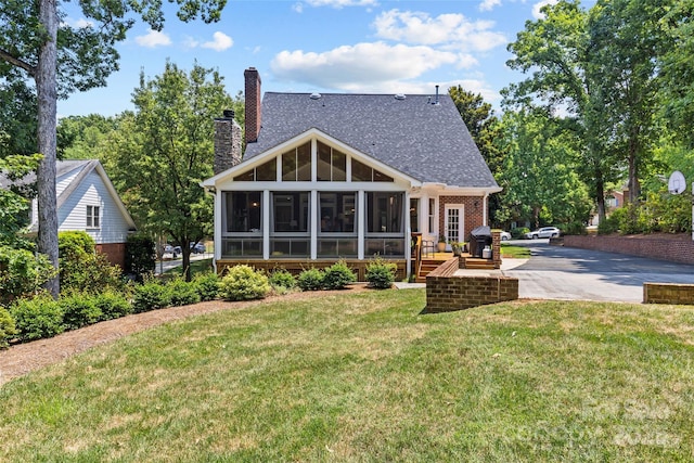 6716 Southby Ct, Charlotte, NC 28270 - rear view of property featuring a sunroom, a chimney, a lawn, and a shingled roof