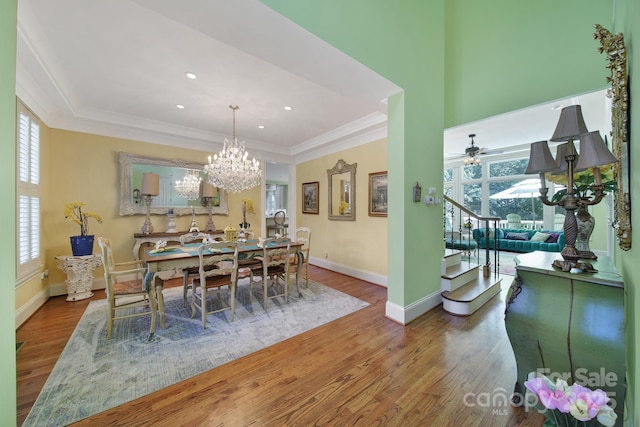 166 Atlantic Way, Mooresville, NC 28117 - dining area featuring wood finished floors, a raised ceiling, stairs, crown molding, and plenty of natural light