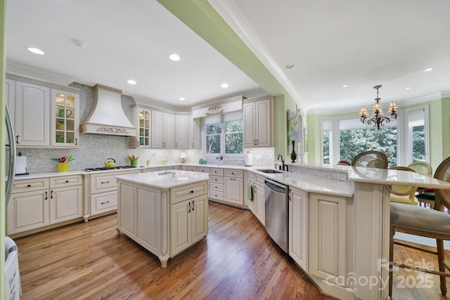 166 Atlantic Way, Mooresville, NC 28117 - kitchen with stainless steel dishwasher, custom exhaust hood, a breakfast bar, a peninsula, and ornamental molding