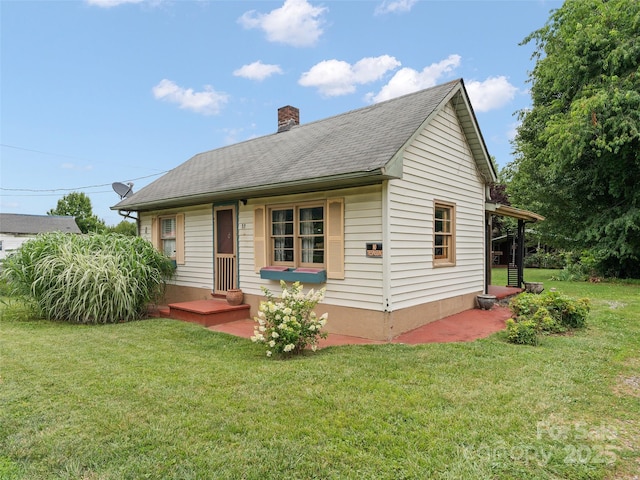 51 Riverbend St, Waynesville, NC 28786 - view of front of home with a chimney, a front yard, and roof with shingles