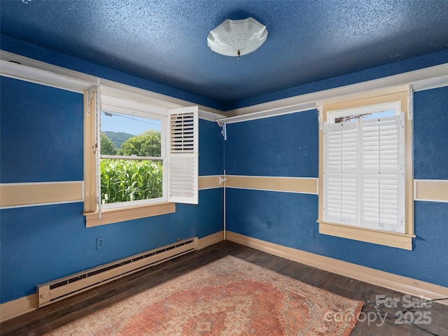 51 Riverbend St, Waynesville, NC 28786 - empty room featuring a baseboard heating unit, wood finished floors, and a textured ceiling