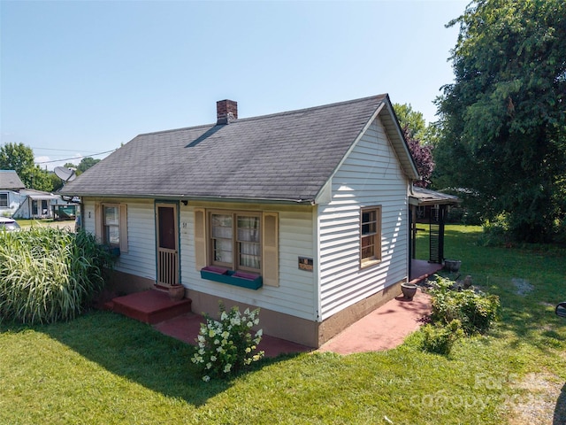 51 Riverbend St, Waynesville, NC 28786 - bungalow-style home featuring a chimney, a front lawn, a shingled roof, and entry steps