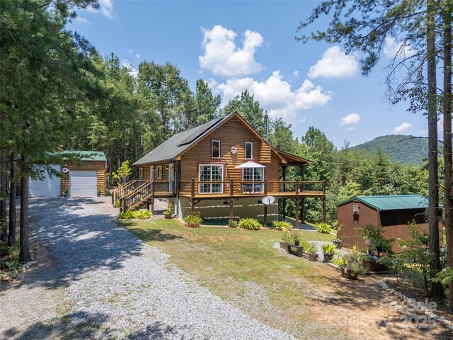 334 Arbra Mountain Way, Bostic, NC 28018 - log-style house with an outbuilding, a wooden deck, driveway, log exterior, and a garage