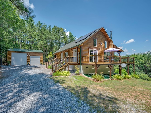 334 Arbra Mountain Way, Bostic, NC 28018 - log cabin with an outbuilding, roof mounted solar panels, a detached garage, stairway, and a deck