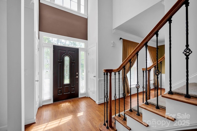 5138 Foxbriar Trl, Charlotte, NC 28269 - entrance foyer with stairs, wood finished floors, a high ceiling, wainscoting, and a decorative wall
