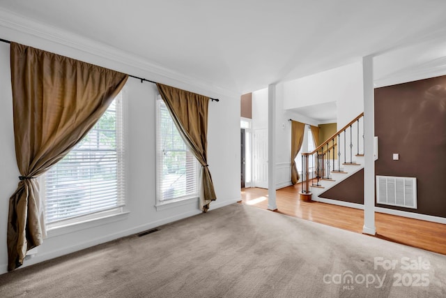 5138 Foxbriar Trl, Charlotte, NC 28269 - unfurnished living room featuring carpet flooring, stairs, and ornamental molding