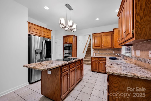 5138 Foxbriar Trl, Charlotte, NC 28269 - kitchen with appliances with stainless steel finishes, tasteful backsplash, light tile patterned flooring, light stone counters, and a kitchen island