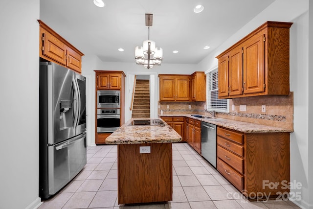 5138 Foxbriar Trl, Charlotte, NC 28269 - kitchen with stainless steel appliances, a kitchen island, backsplash, a chandelier, and brown cabinets