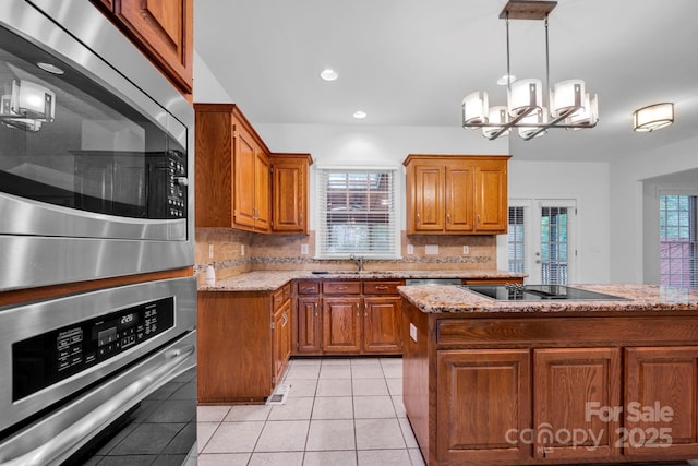 5138 Foxbriar Trl, Charlotte, NC 28269 - kitchen with appliances with stainless steel finishes, brown cabinets, decorative backsplash, and recessed lighting